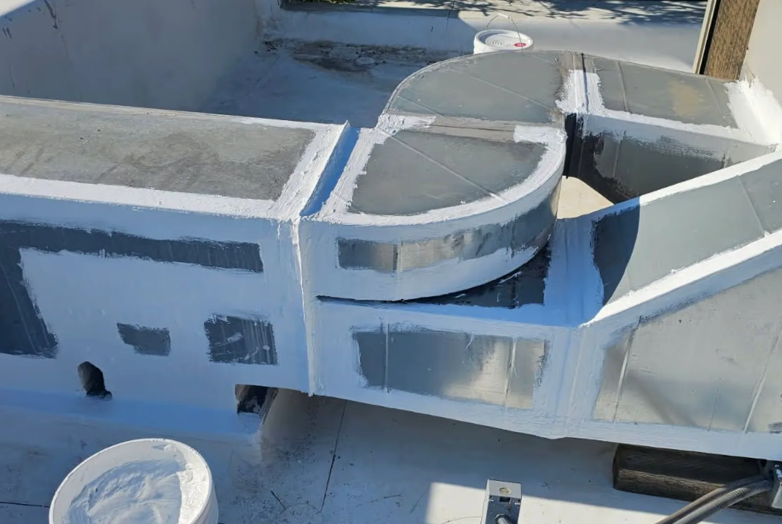 Protective roof coating around rooftop HVAC equipment